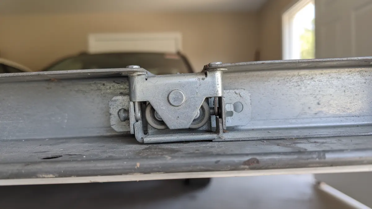 A garage door roller is visible on a metal track.